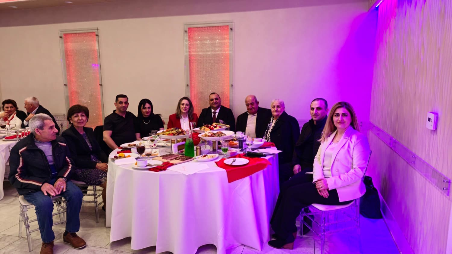 Couples around the table at an evening in the hall