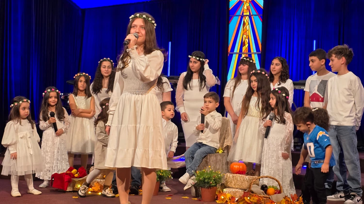 The harvest programme — a girl singing, the others behind her