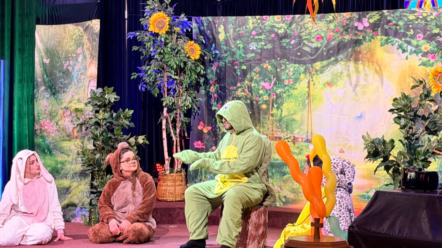 A scene from the programme, on the painted garden set