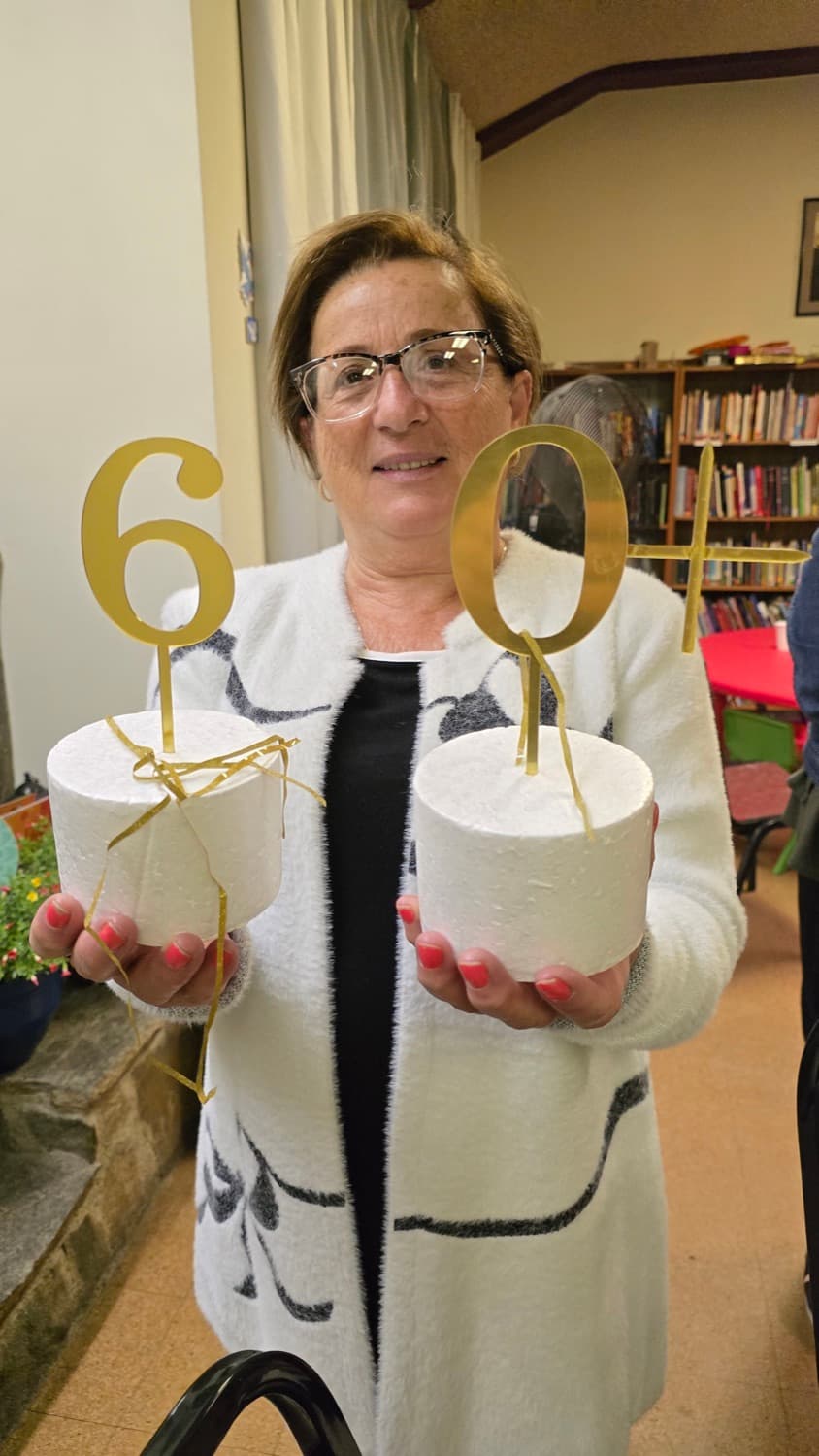 A guest at the 60+ gathering, holding the gold numerals