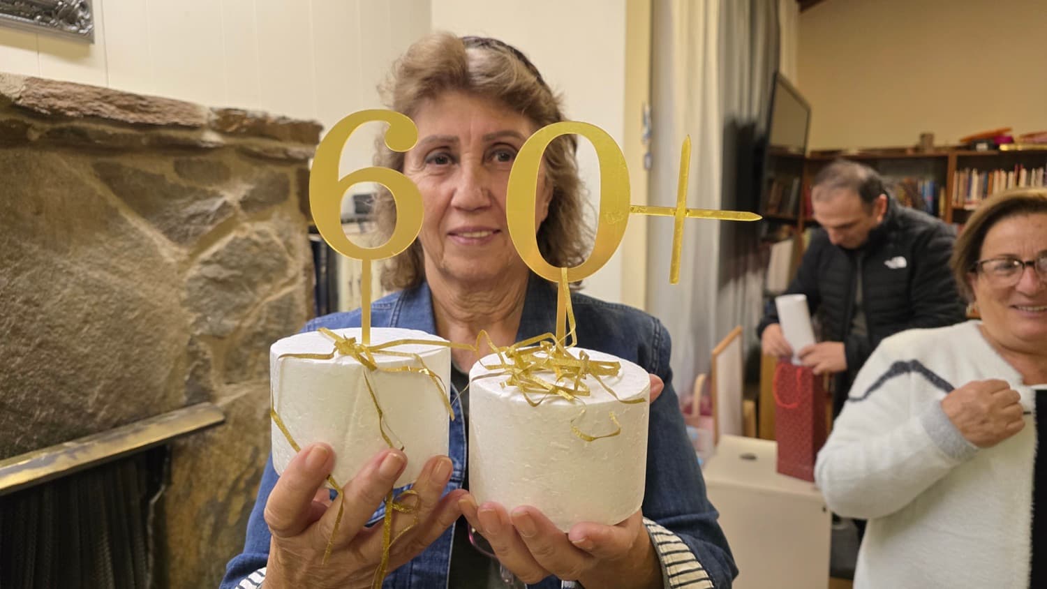 A guest at the 60+ gathering, holding the gold numerals