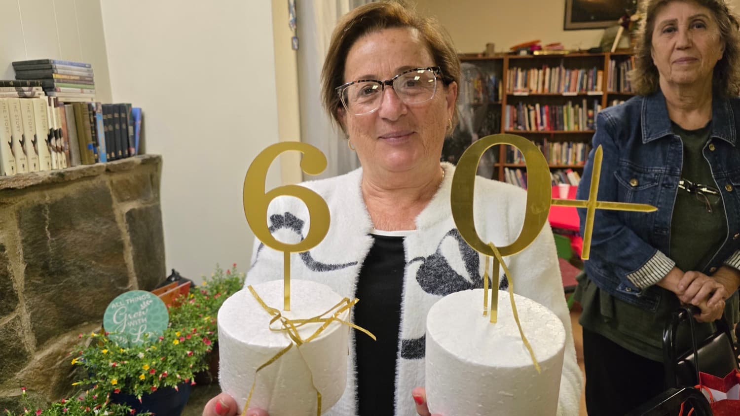 A guest at the 60+ gathering, holding the gold numerals