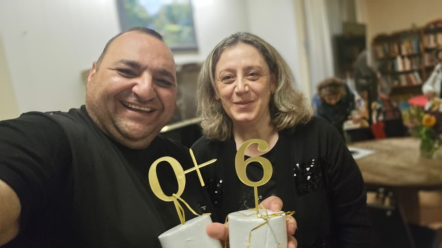 A guest at the 60+ gathering, holding the gold numerals